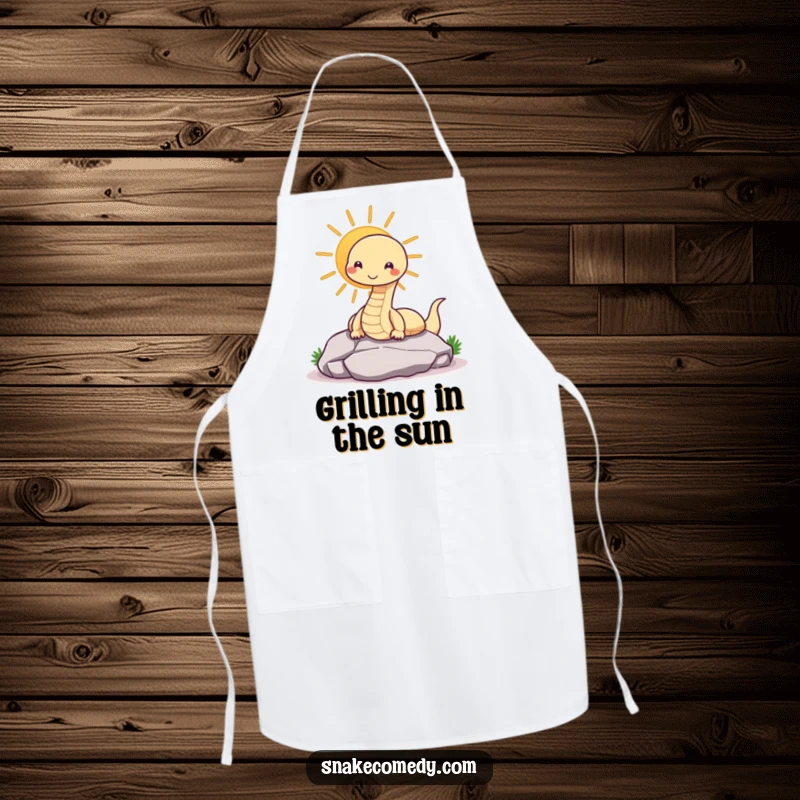 Funny snake apron showing a contented snake sunning on a rock, adding humor to kitchen tasks.
