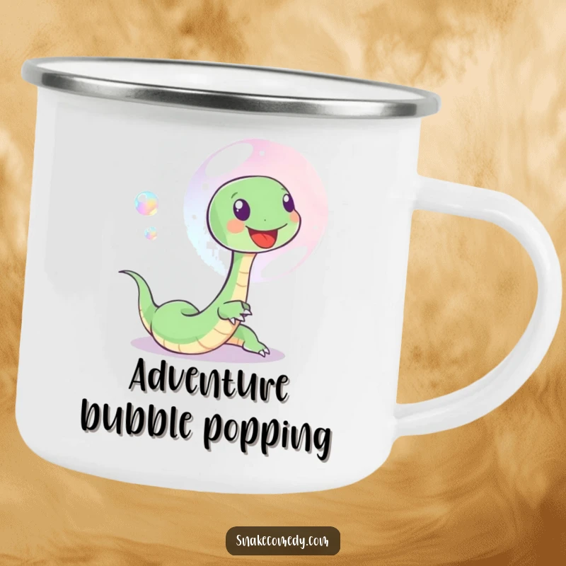 Funny camping mug with a small, happy snake playfully chasing a shimmering bubble, perfect for outdoor fun and cheer.