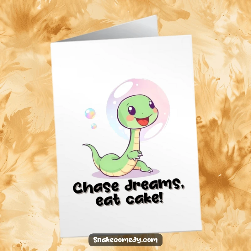 Funny Free Printable Birthday Card of a playful snake joyfully chasing a shimmering, iridescent soap bubble, spreading birthday wishes and lighthearted fun.
