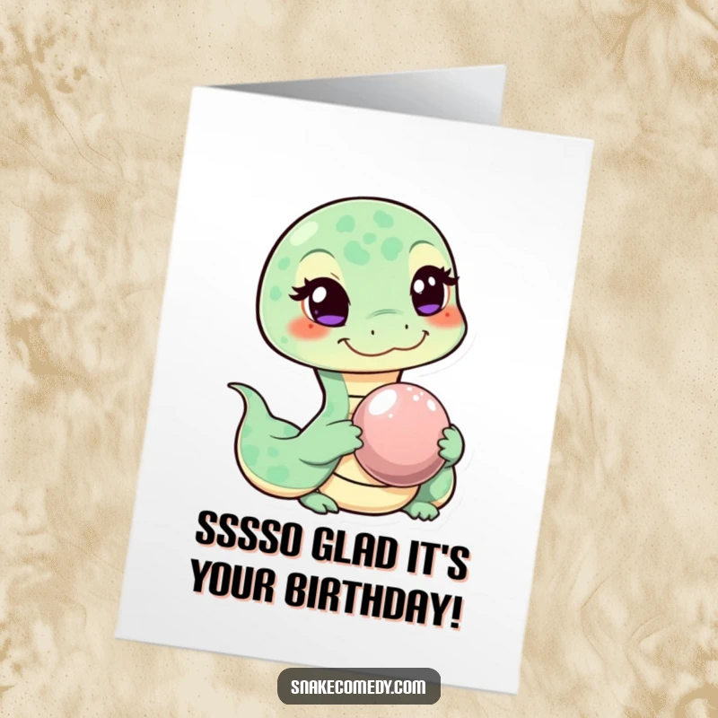 Funny Free Printable Birthday Card: Mischievous snake winks, holding a shiny pebble, offering a playful birthday wish.