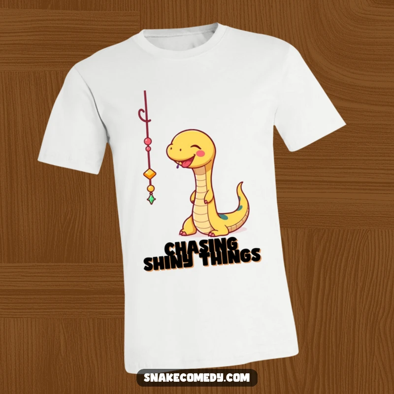 Funny Snake T-Shirt: A cheerful snake joyfully bats at a shiny, dangling charm, radiating playful energy.