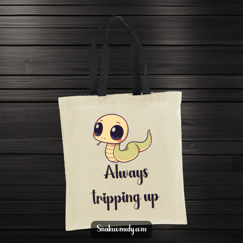 Funny snake with big, round eyes tripping over its tail, depicted on a practical and humorous tote bag for everyday use.
